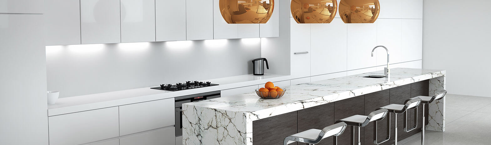 A kitchen with marble counter tops and white cabinets.